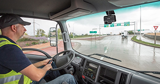 Driver on wet road with dash cam